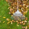 Fall Leaves on lawn being raked into a pile