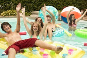 Teenage boys and girls playing in a pool