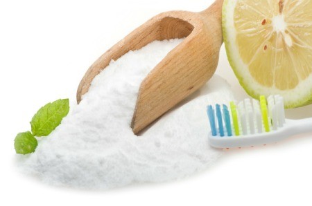 Baking Soda, Lemon, Mint and a Toothbrush displayed on a white background
