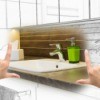 Hands framing renovated bathroom brought to life from a sketch