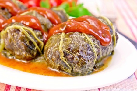 Rhubarb leaves stuffed with meat and topped with a rhubarb sauce