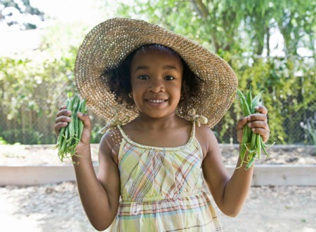 Girl holding two handfuls of fresh green beans