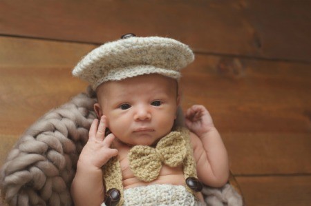 Infant wearing knitted newsboy cap