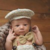 Infant wearing knitted newsboy cap