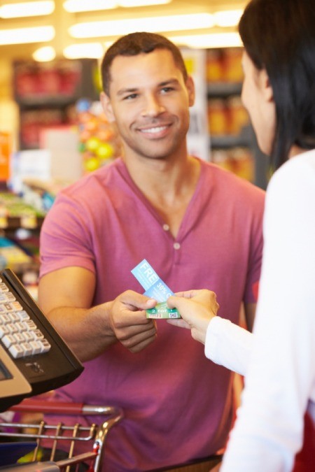 Man Using Food Stamps at Supermarket