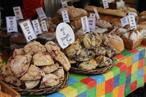 Scones and loaves of breads laid out with prices on a table