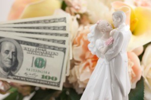 Bride and Groom porcelin decoration next to hundred dollar bills