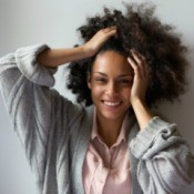 African American Woman with hands in her long natural hair