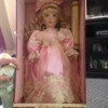 doll wearing pink dress in box