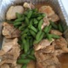 Chicken with Chinese brown sauce in serving dish with green beans.