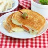 Grilled Cheese and Tomato Sandwich on red plaid tablecloth