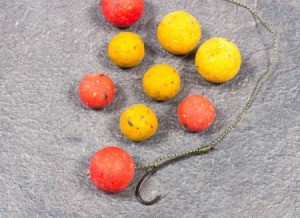 Carp fish hook with orange and yellow bait balls
