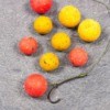 Carp fish hook with orange and yellow bait balls