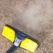 Steam cleaner being run over carpet