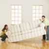 Man and woman carrying a large couch