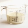 Liquid measuring cup containing cream