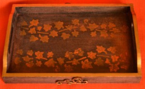 A tray with a stamped "inlay" of leaves.