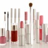 Tubes and bottles of makeup standing upright against a white background