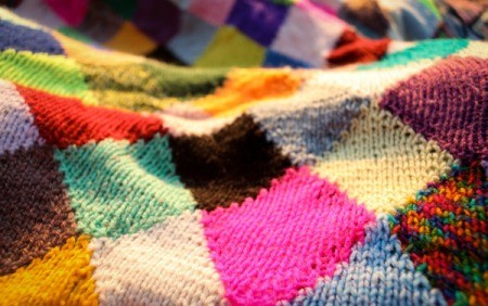 Quilt made from a variety of knitted squares