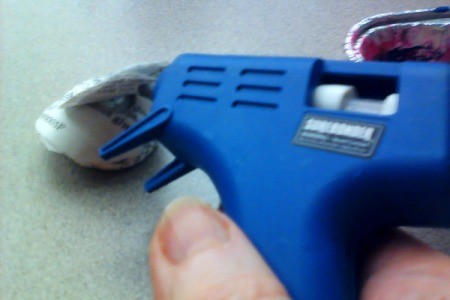Using a glue gun on a rosette.