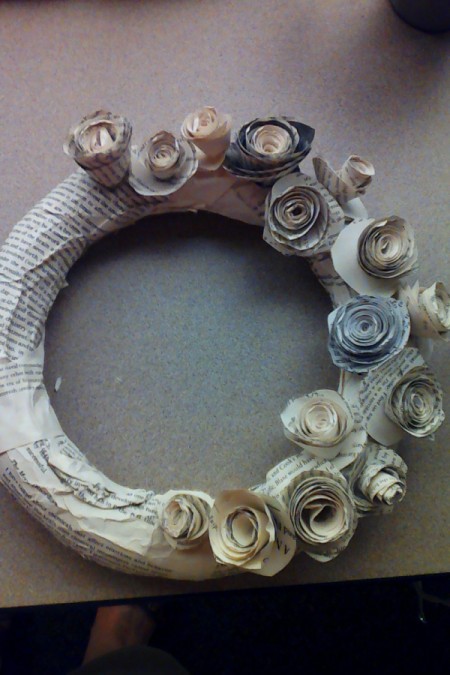 A wreath form with rosettes being added to one side.