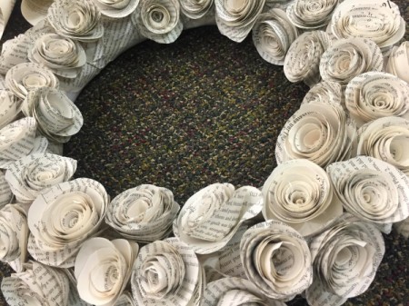 A closeup of a wreath made from paper rosettes.