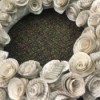 A closeup of a wreath made from paper rosettes.