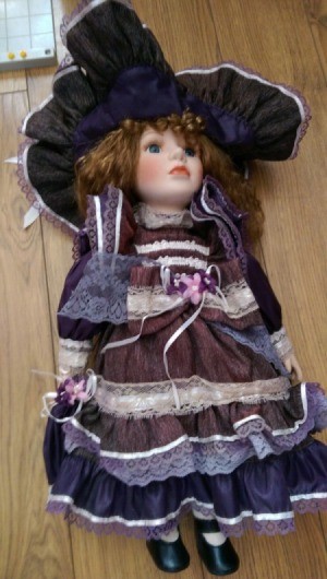 doll wearing purple dress with lace
