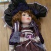 doll wearing purple dress with lace