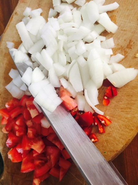 Chopped onions and peppers for the empanadas.