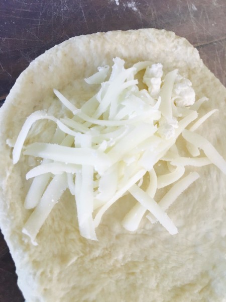 Pizza dough and grated cheese.