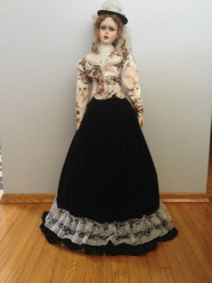 doll with long skirt and short flowered jacket
