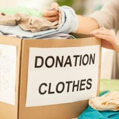 Woman with a box labeled Donation Clothes