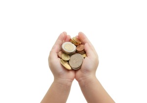 Childs cupped hands holding coins