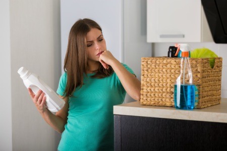 Woman examining cleaning products