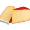 Two triangles of gouda cheese in red wax.