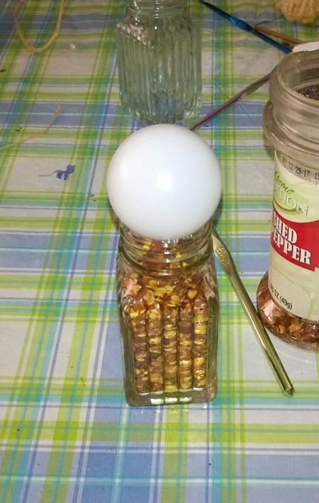 ball head affixed to top of jar