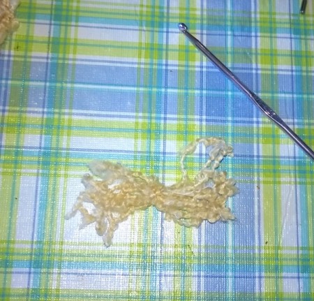 small bundle of cut yard tied together to make the hair