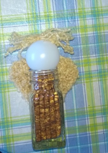 bottle with wings and hair attached