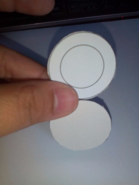 A hand holding the front and back frame templates.