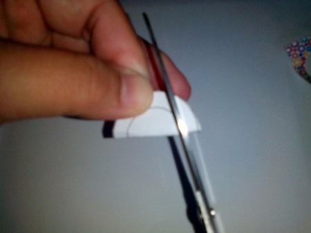 Fold circle in half and cut out the center of the circular fame with scissors.