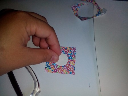 Center circle lying on colored paper square ready for tracing.