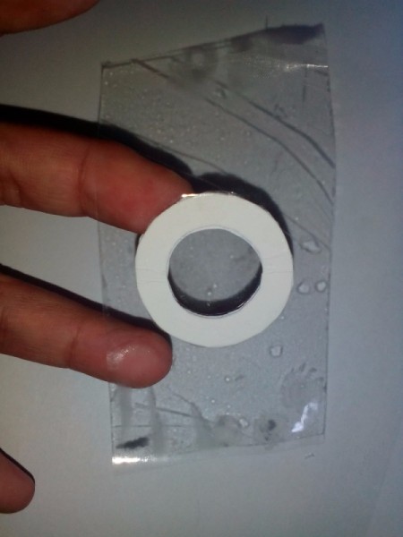 Applying transparent tape to front of colored frame.