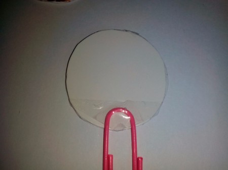 Tape paper clip on the wrong or inside of the frame back.