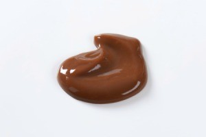 Blob of hocolate pudding isolated on a white background