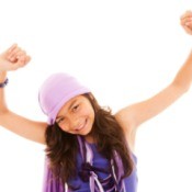 Tween girl dancing against a white background