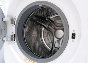 Close up of empty front load washing machine with the door open