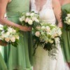 bridesmaids in green dresses standing next to bride