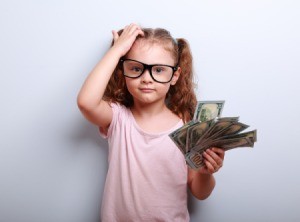 little girl with a fist of money