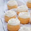 Several vanilla cupcakes with white frosting
